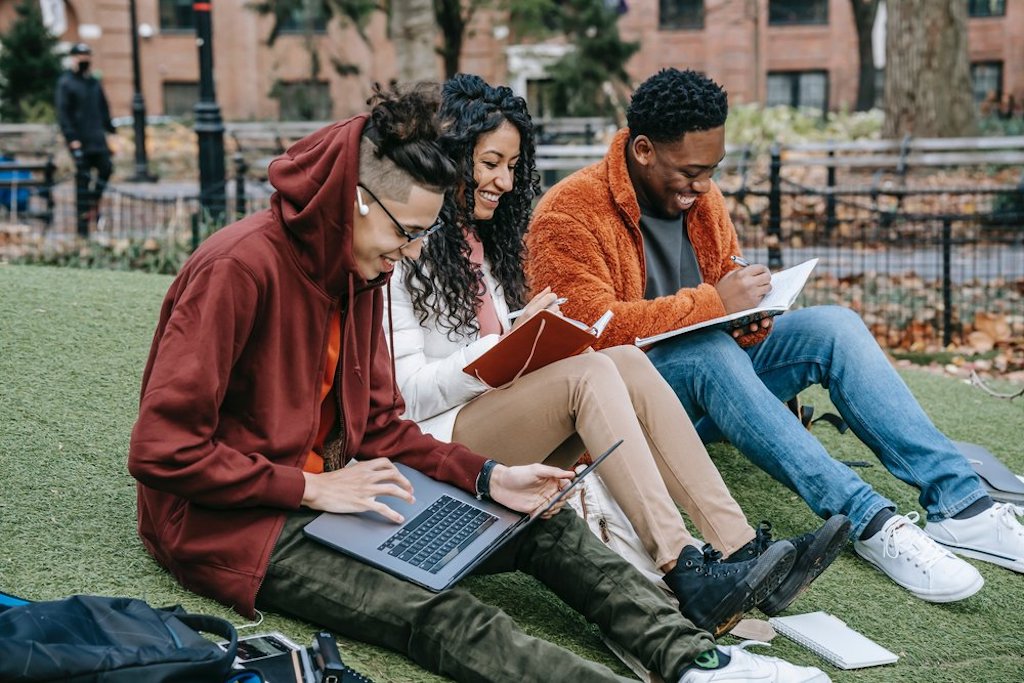 Diverse group of international students study outside.